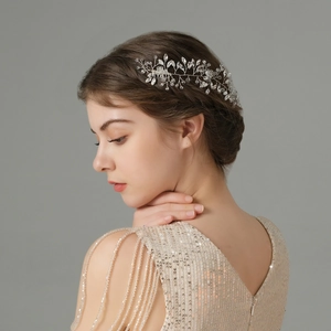 Detailed view of hand-woven crystal bridal hair comb accessory on bride hairstyle