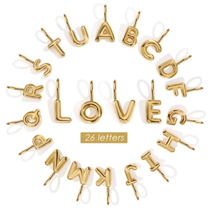 Detailed view of 26 golden 14K vacuum plated bubble letter DIY jewelry pendants