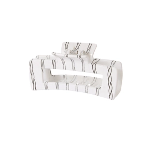 Detail view of large 10.5cm hair claw clip with grey wave pattern on cream plastic