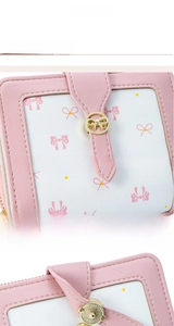 Detail of pink bow wallet featuring gold hardware and patterned fabric stitching