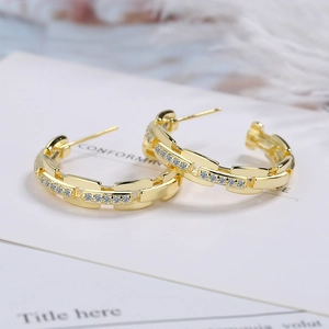 Golden chain-style hoop earrings with micro-pave cubic zirconia on white card background