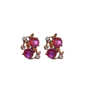 Vintage gold-tone flower leaf earrings featuring deep red gemstones and sparkling rhinestones