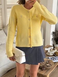 Women's yellow knitted cardigan with long sleeves and gold buttons in a short cropped style
