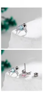 Detailed view of crescent moon stud with blue zircon and secure screw back closure