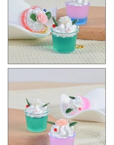 Close-up of miniature dessert keychains with layered jelly and cream floral details