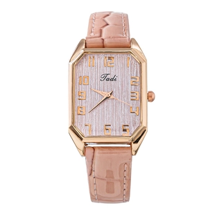 Detail of rose gold rectangular watch with pink textured dial and leather strap