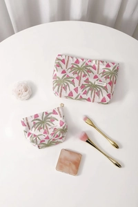 Detail of two-piece floral canvas makeup bags with palm tree patterns and flower zippers