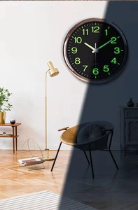 Luminous 12 inch wall clock showing day and night glowing effect in a living room