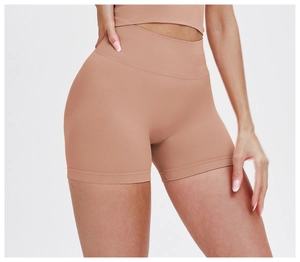 Detail of high-waist seamless yoga shorts showing the ribbed waistband and nude fabric texture