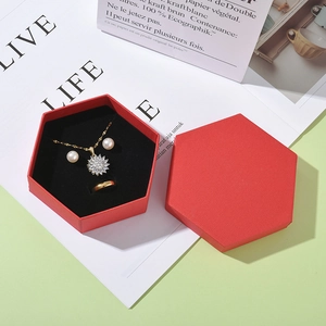 Red hexagonal jewelry gift box set containing gold necklace, pearl earrings and ring