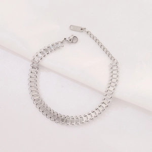 Detailed macro view of silver stainless steel Cuban chain bracelet with lobster clasp