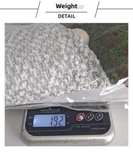 Detailed view of Christmas wreath weighing 192g on a scale in clear plastic packaging