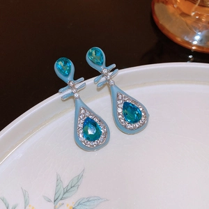 Detail of Pipa teardrop earrings with blue enamel and sparkling rhinestones on ceramic