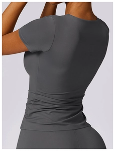 Close-up of slim fit yoga shirt featuring pleated back design and breathable fabric