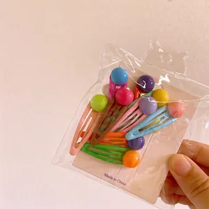 Handheld pack of colorful resin mini bear and heart hair clips on white cardstock