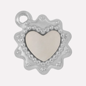 Macro detail of 304 stainless steel heart pendant with white shell and beaded edge