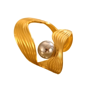 Detailed view of gold irregular geometric ring with rippled texture and silver beads