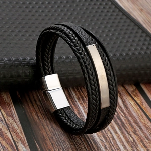 Close-up of black braided leather multi-layer men's bracelet with metal magnetic clasp