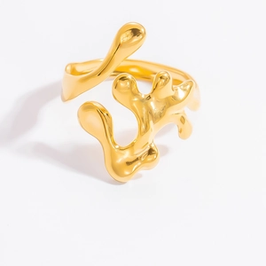 Macro shot of gold-plated minimalist branch ring featuring abstract liquid metal design