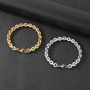 Detail of interlocking gold and silver stainless steel chain bracelets with lobster clasp