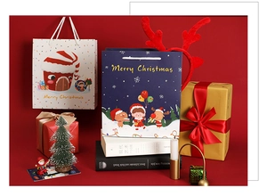 Detail of Christmas gift bags featuring cute cartoon girl illustrations and cotton handles