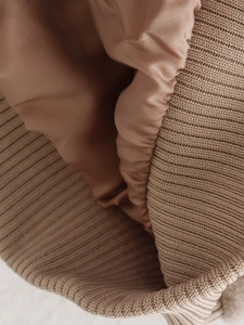 Detail of pink-brown tweed jacket showing silky satin lining and ribbed knit texture