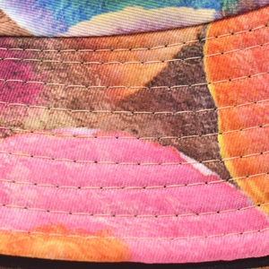 Close-up of high-density twill cotton fabric with colorful tie-dye print and reinforced stitching