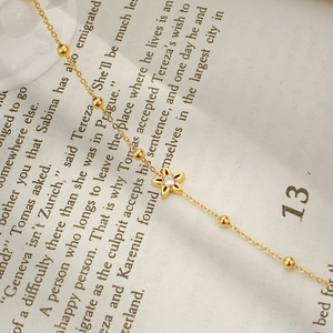 Elegant gold-plated stainless steel star bracelet with a sparkling zircon on a book