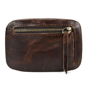 Detail of vintage brown cowhide leather coin purse with stitching and metal zipper
