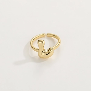 Macro shot of gold-plated adjustable ring featuring a fluid molten metal texture design
