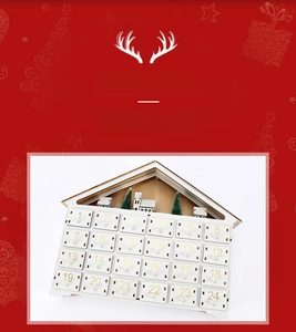 Close-up of white wooden advent calendar with 24 numbered drawers and miniature trees