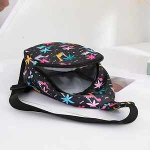 Detail of kids chest bag showing interior storage and colorful dinosaur prints on nylon