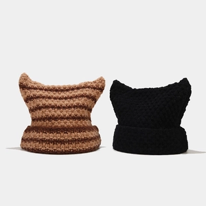 Detailed knit texture of devil ear beanies in brown stripes and solid black colors