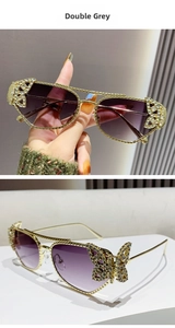 Macro detail of butterfly rhinestone ornament on gold metal frame purple gradient lens sunglasses