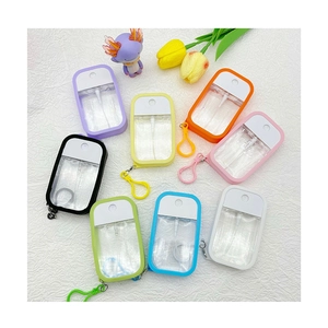 Flat lay of colorful portable spray bottles with silicone cases and hooks in eight colors