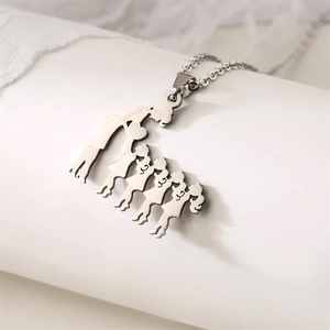 Macro shot of silver stainless steel family silhouette pendant for mother daughter son