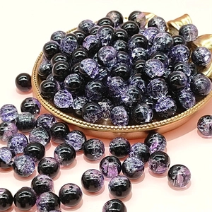 Macro shot of 10mm black and purple cracked glass beads for DIY jewelry making
