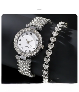 Close-up of silver quartz watch and heart bracelet set with crystal rhinestones