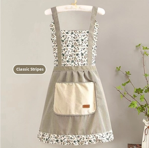 Détail de tablier en toile à rayures et fleurs avec grande poche et étiquette mode