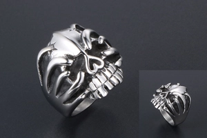 Macro detail of retro skull ring showing vintage punk steel texture and carving