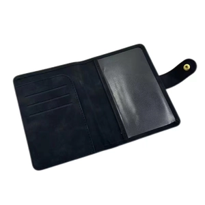 Detail view of black PU leather RFID passport holder with card slots and transparent window