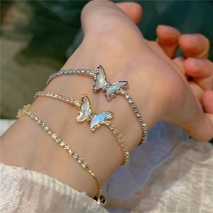 Close-up of butterfly bracelets with iridescent shell inlay and cubic zirconia chains