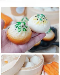 Detailed macro view of realistic PVC steamed buns showing fine texture and green onion decor