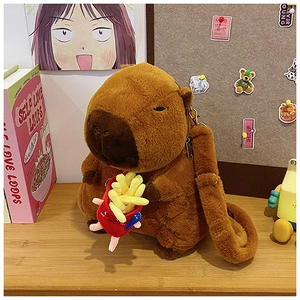 Close-up of brown plush capybara backpack with a red french fries keychain charm