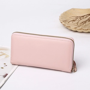 Detailed view of pink long wallet with smooth PU leather finish and wristlet strap