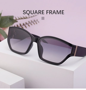 Detail of square black sunglasses with purple gradient lenses on minimalist white cubes