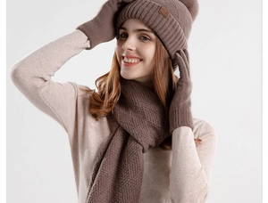 Close-up of coffee brown knitted winter set including beanie hat scarf and gloves