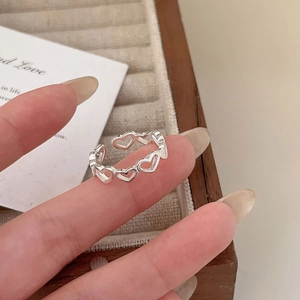 Elegant 925 sterling silver hollow heart ring worn on finger for a minimalist look