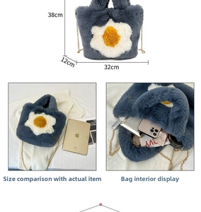 Detail view of large blue plush tote bag with egg charm showing size and capacity