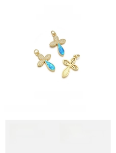 Detail of 18K gold plated clover cross pendant with blue opal and cubic zirconia